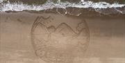 Sand Art created on Penbryn Beach to celebrate World Refil Day, 16th June 2022