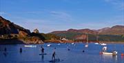Barmouth in Southern Snowdonia is a great location for Mountain, Sand and Sea. Extensive sandy beach with attractions, water sports and boat trips. Si