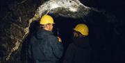 Exploring the broad tunnels and cavernous chambers with Corris Mine Explorers