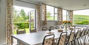 Dining room at Hafren Forest Hideaway with rural hill and farmland views, ideal for group accommodation in Mid Wales