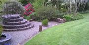 Stone feature in the shape of a church pulpit that can be climbed as a viewing point over the blue garden