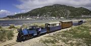 Fairbourne Railway running through the dunes on Fairbourne Beach