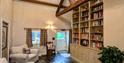 Lounge area with exposed beams and large bookcase