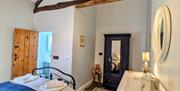 Interior bedroom with view of ensuite bathroom to left of room