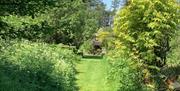 Path through gardens up to the cottages.