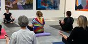 Yoga class in session in the gallery.