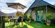 The garden deck outside Tollant with views over the hills and meadows.