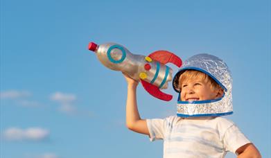 Young child holding a handmade bottlerocket