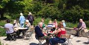 Visitors enjoying the sun on the patio at Cae Hir tearoom