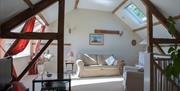 Sitting room at Granary Cottage, TV with freeview, DVD player, books, good lighting.