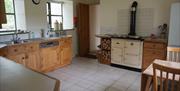 Large fully equipped kitchen with wood-fired range cooker