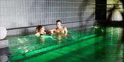 Two people in a pool in spa area