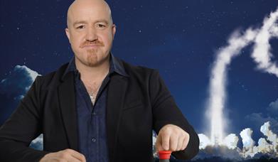 Man pressing a button with rocket launching behind him