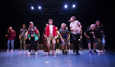 Young people jumping on a theatre stage