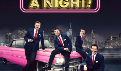 Suited Men on a pink car with city back drop