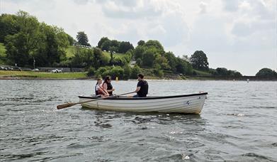 Rowing boat at Llandegfedd Lake with family in.