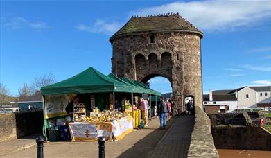 Monnow Bridge Markets - Local Produce stalls / green tents on Monow Bridge over river