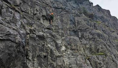 People belaying rock climbers