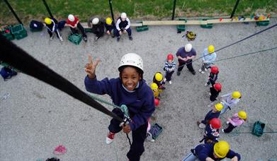 Abseiling off wall