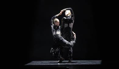 Two dancers in bright lights in action