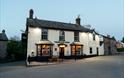 THE TREDEGAR ARMS exterior of building - black and white on the side of the road looks welcoming with warm lights showing through window