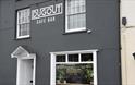 The Dugout Café bar
outside dark grey building with white windows