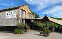 Craft Renaissance Kitchen & Cafe wooden building very stylish with planters and sun canopy, blue sky and green fields in background in rural monmouths