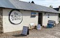 quant brick barn with The makers studio sign on the side, art work