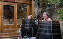 Woman and man laugh in cold plunge as cold water spills out of cold plunge barrel in Stone Rock Lodge
