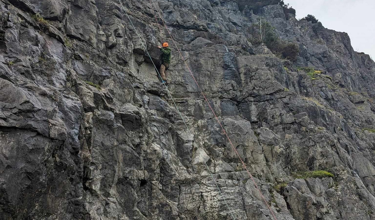 People belaying rock climbers