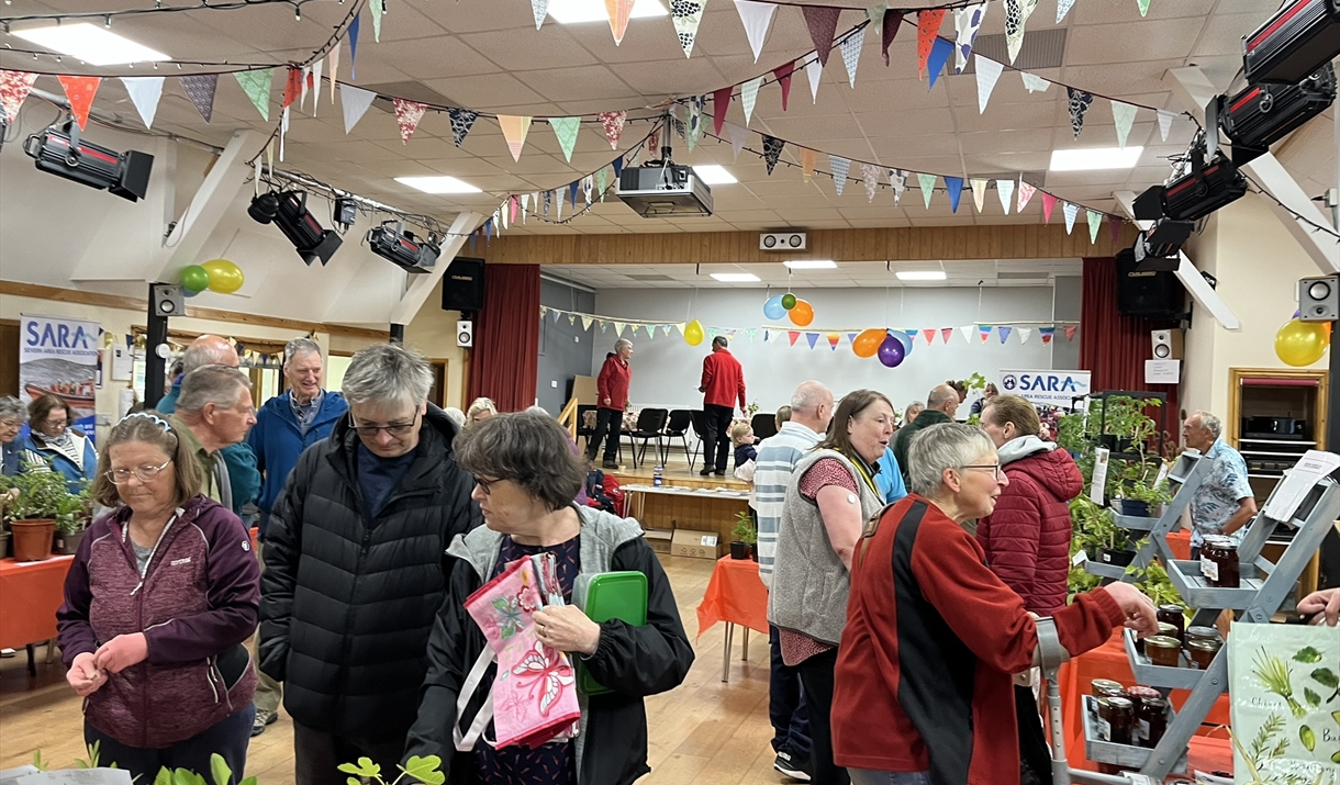 Busy Catbrook Plant sale with people enjoying the plans on sale in the village hall near chepstow