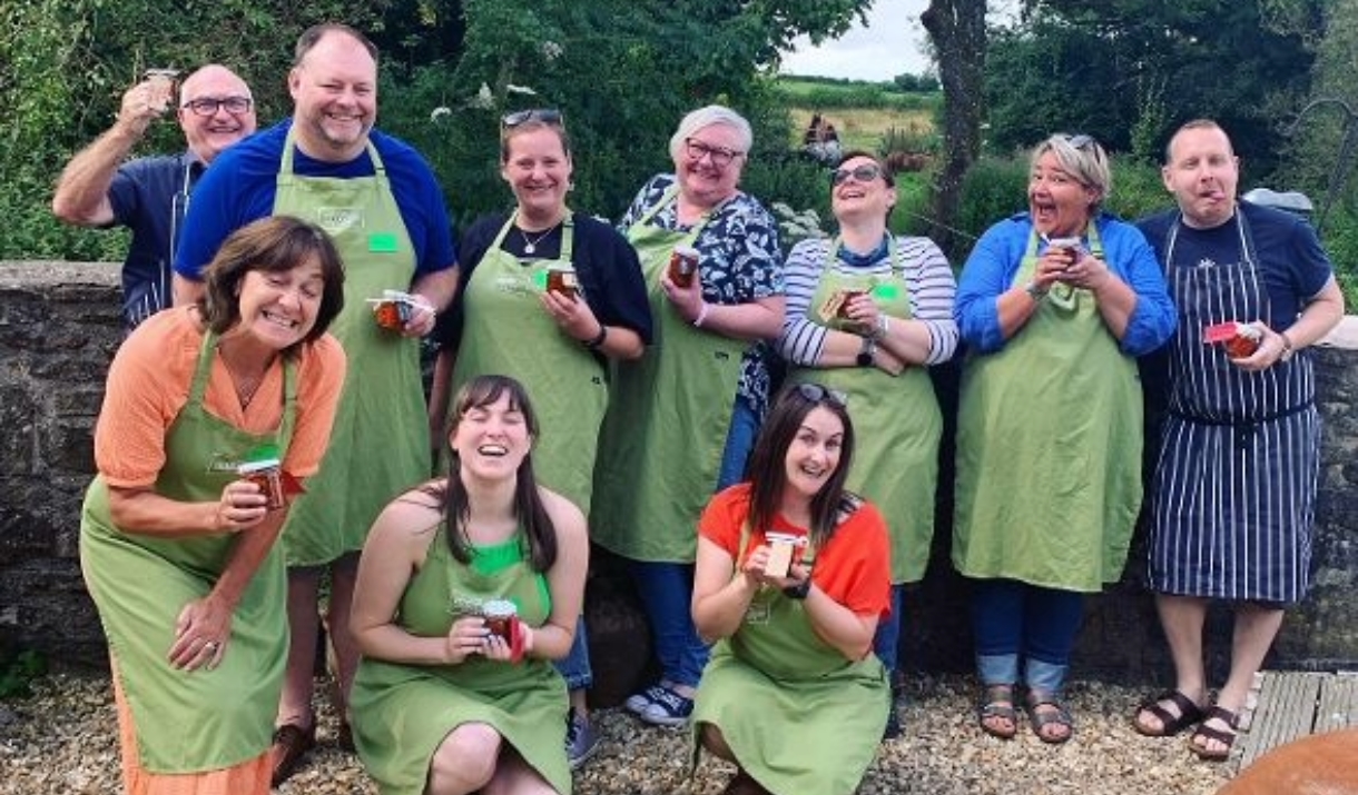 Our Hot Sauce Chilli Course celebrates group smiles and makes silly faces - tongues out and laughing whilst holding a jar of pickle chillies