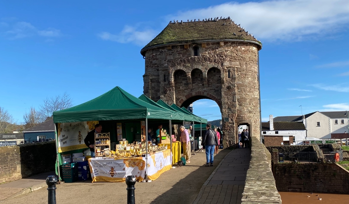 Monnow Bridge Markets - Local Produce stalls / green tents on Monow Bridge over river