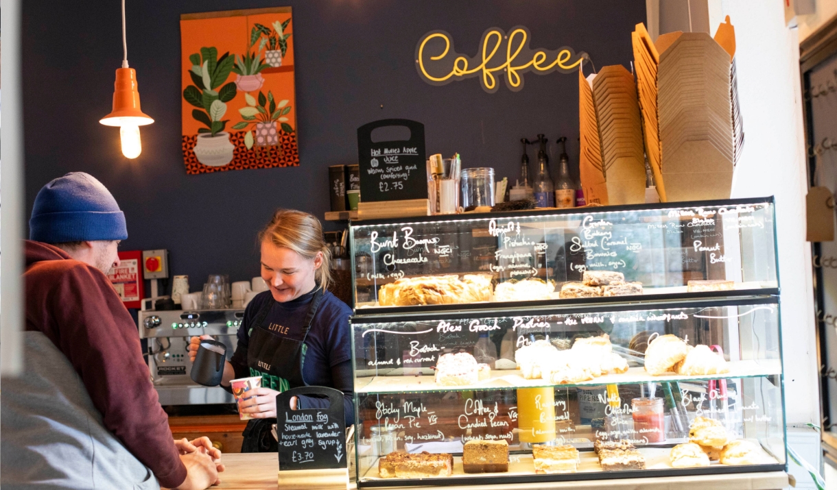 Little Green Refills - The Coffee House lady pours fresh coffee with baked cakes and food