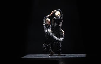 Two dancers in bright lights in action