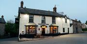 THE TREDEGAR ARMS exterior of building - black and white on the side of the road looks welcoming with warm lights showing through window