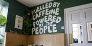 fulled by caffeine powered by the people on wall sign