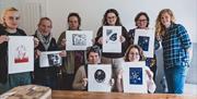 Lino print workshop in Monmouthshire group of people showing their art work and being happy