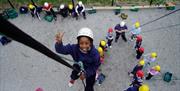 Abseiling off wall