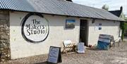 quant brick barn with The makers studio sign on the side, art work