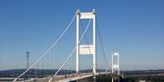 Severn Bridge, older of the two bridges, show against a blue sky