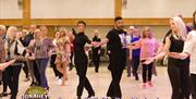 Giovanni Pernice and Lauren Oakley teaching the cha cha