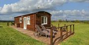 Harvest Home Shepherd Lodges made of wood looks like shepherds hut in field blue skys in monmouthshire near cardiff