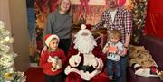 Santa at Llandegfedd Lake in Grotto with a family