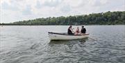 Rowing boat at Llandegfedd Lake with family in.