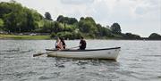 Rowing boat at Llandegfedd Lake with family in.