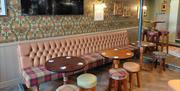 inside pub, comfy chairs and table and seats