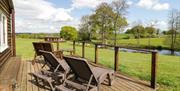 Harvest Home Shepherd Lodges chairs overlooking pond