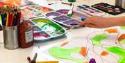 Pawb Arts in Abergavenny showing craft items and child painting
