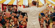 Devauden Music Festival 2025  circus tent with children and families watching performer